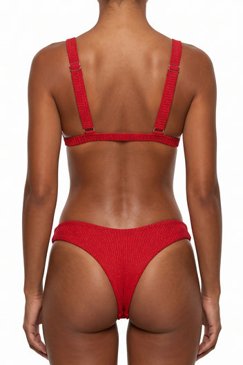 Back view of terracotta red ribbed bikini with thin adjustable straps across the back and a cheeky cut brief bottom