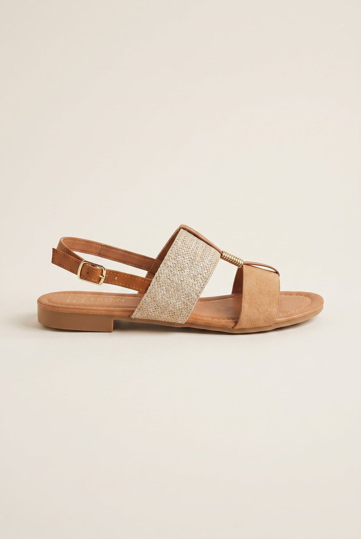 Tan leather flat sandal with straw woven panel across the front and adjustable ankle strap with buckle