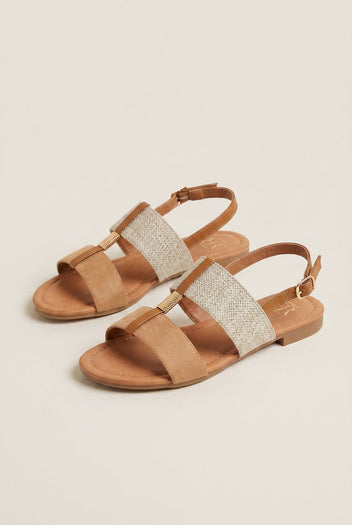 Pair of flat sandals with camel suede toe strap, woven straw band, tan leather ankle straps with gold buckles and low heel, three-quarter view