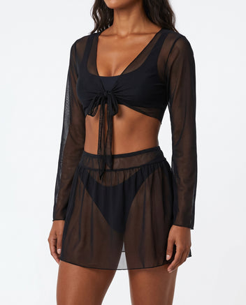 Model wearing black sheer long-sleeve tie-front crop top and mesh mini skirt, front view