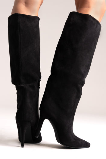 Black faux suede pointed-toe stiletto knee-high boots with slouchy shaft, back view on a model