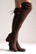 Brown faux suede over-the-knee boots with drawstring tie and block heel, side view on a model's legs