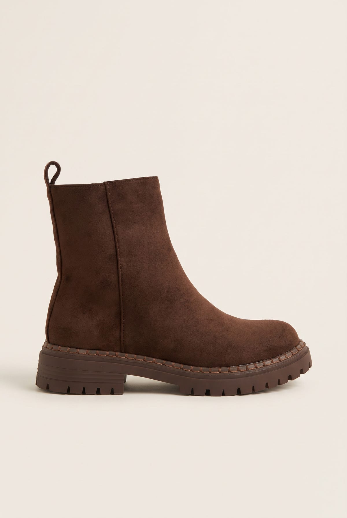 Side view of mocha brown suede ankle boot with side zipper, pull tab at heel and thick lugged rubber sole