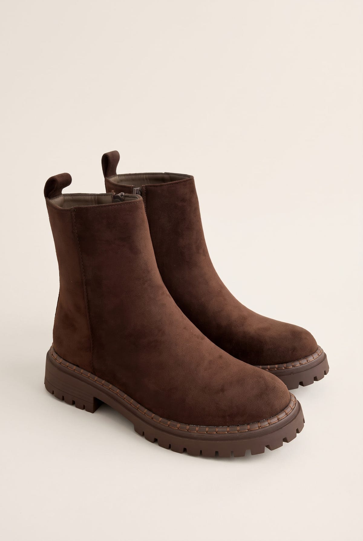 Pair of mocha brown suede ankle boots angled side by side showing rounded toes and chunky lugged soles