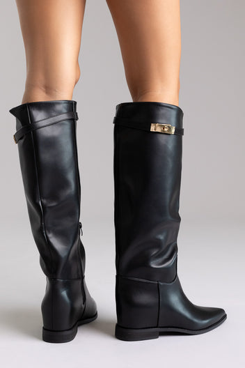 Black leather knee-high boots with gold buckle detail and block heel, angled view on a model
