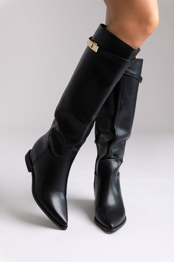 Black leather knee-high boots with gold buckle detail and block heel, angled view on a model
