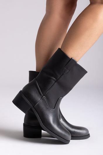 Black leather mid-calf boots with block heel and side panel, pair in side view on a model's legs in studio light
