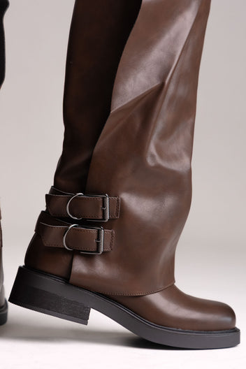 Brown leather knee-high boot with buckle straps and chunky sole, close side view on a light grey background
