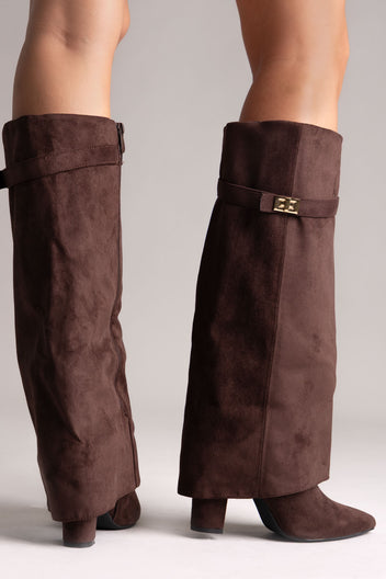 Dark brown faux suede fold-over knee-high boots with gold buckle strap and block heel, front angled view on a model