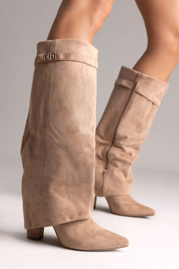 Taupe suede fold-over knee-high boots with gold buckle strap and pointed toe, front angled view on a model