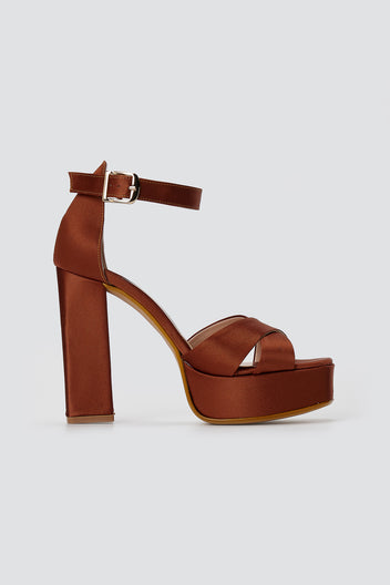 Rust brown satin platform sandal with crossed front straps, gold buckle ankle strap and block heel, side view