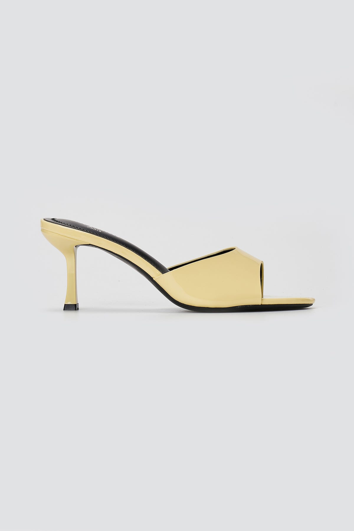 Pale yellow patent mule sandal with square open toe, wide front band and flared slim heel, side view