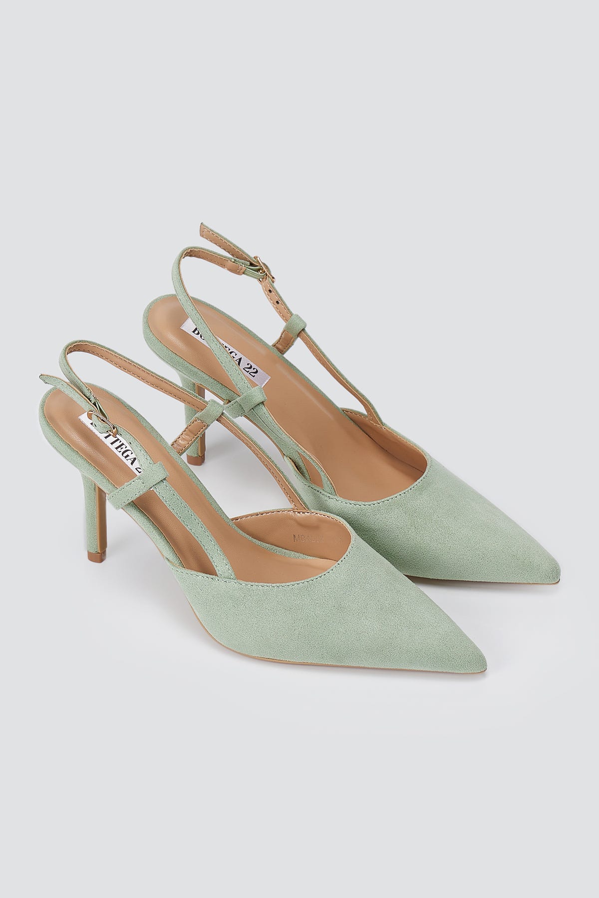 Pair of mint green suede slingback pumps, three-quarter view, pointed toes, thin cross straps and stiletto heels