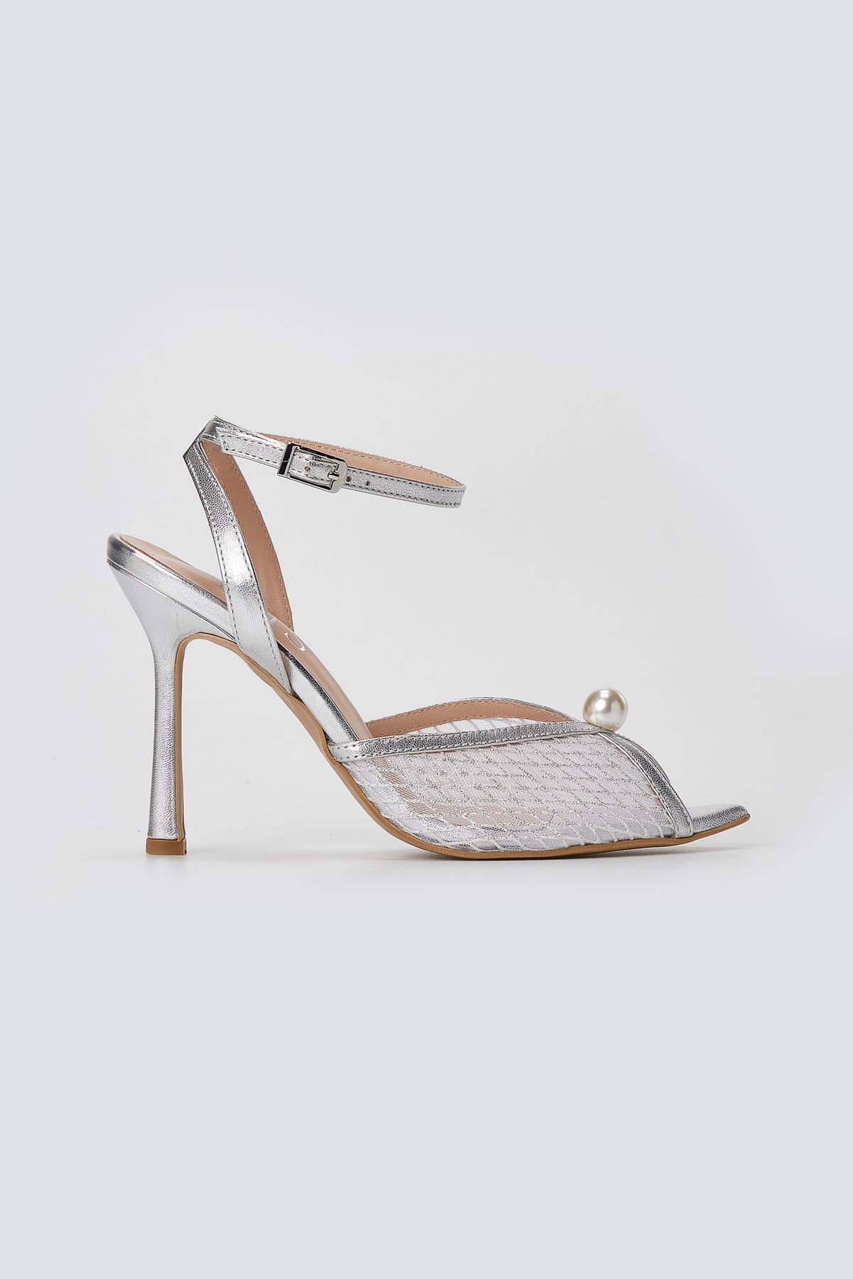 Silver metallic sandal with clear mesh peep toe, pearl bead, ankle strap and slim high heel, side view