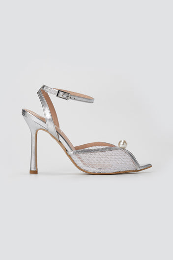 Silver metallic sandal with clear mesh peep toe, pearl bead, ankle strap and slim high heel, side view