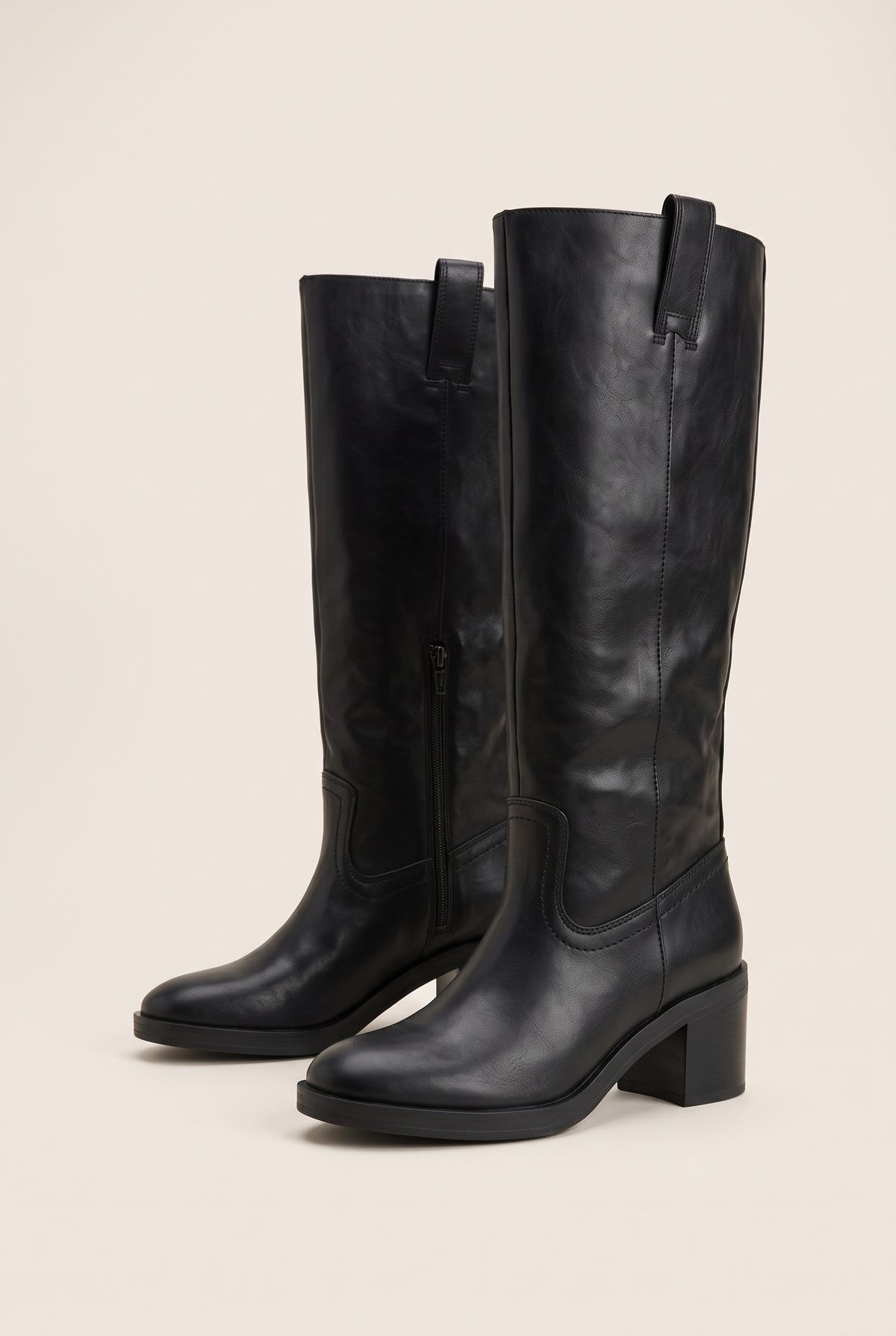 Pair of black leather knee-high boots, three-quarter view, pull tabs, side zip, round toes and block heels