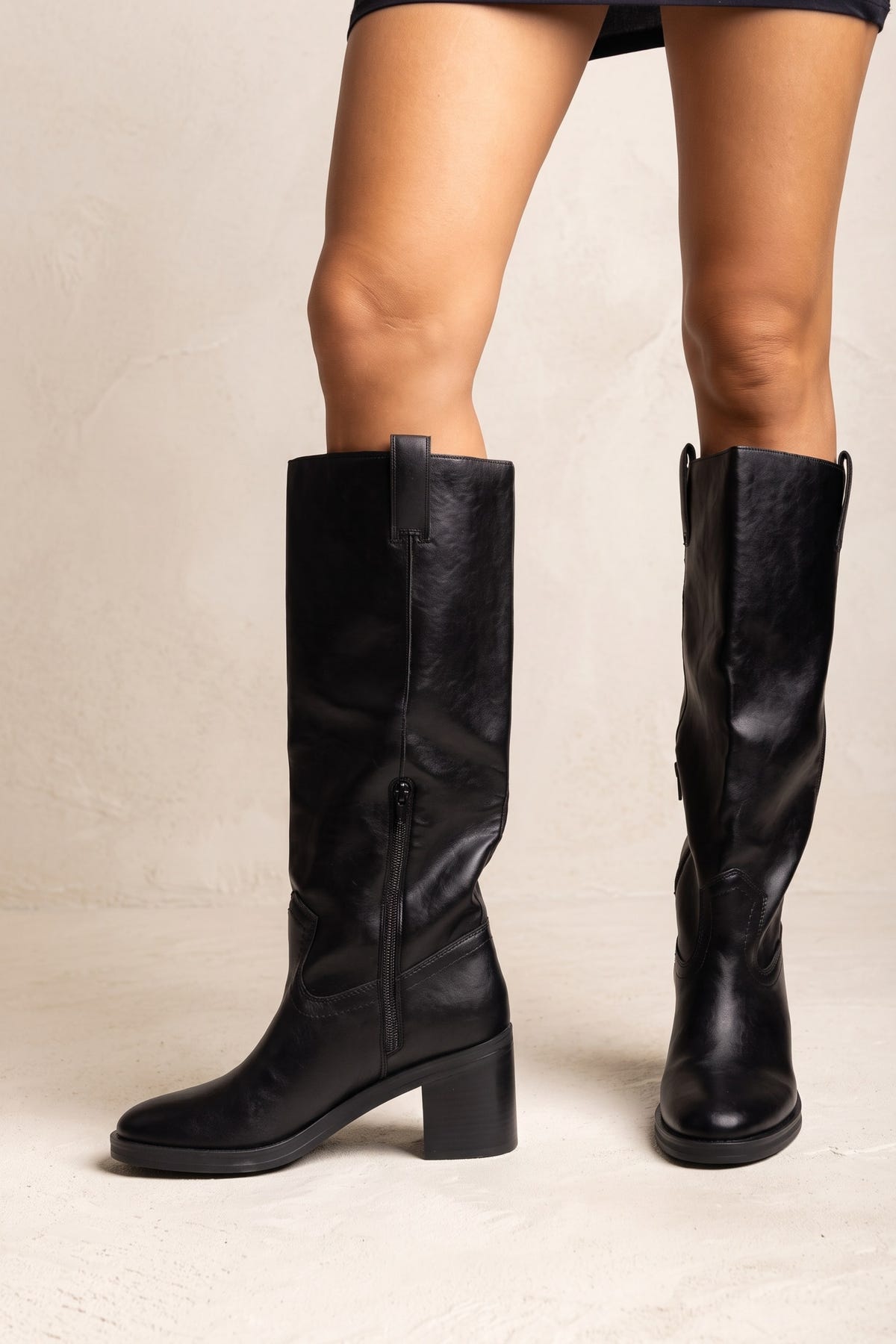 Black leather knee-high boots with pull tab, side zip, almond toe and block heel, front view, worn on model