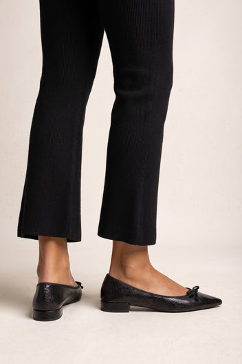 Black snake-embossed leather pointed flats with bow detail and low block heels, back and side view worn on model