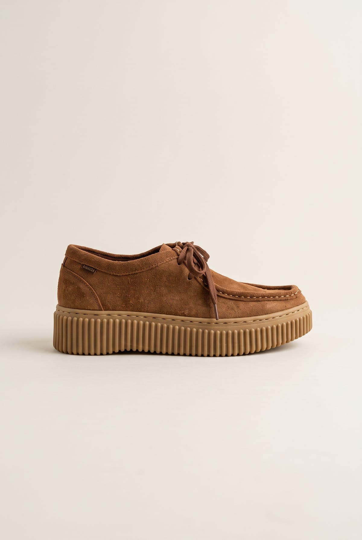 Tan suede lace-up creeper shoe with crepe rubber sole, outer side view on a light beige background