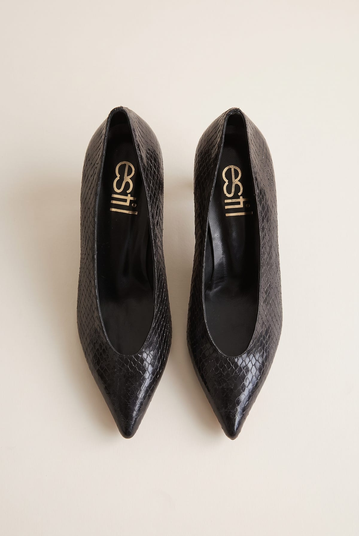Top view of black snake-effect pointed pumps with a low-cut vamp and kitten heels, insole visible inside