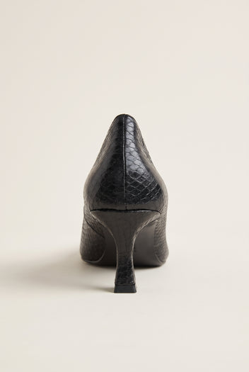 Back view of black snake-effect pump showing the pointed heel counter and slender kitten heel