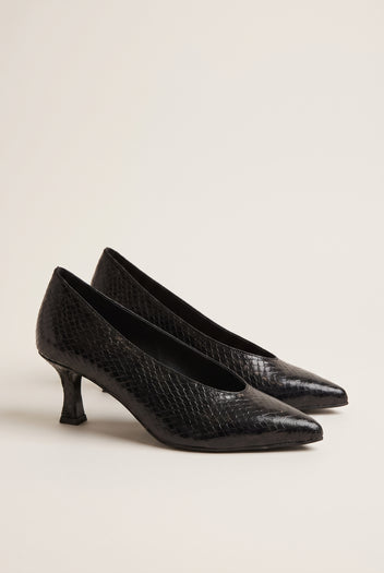 Pair of black snake-effect pointed pumps with kitten heels resting side by side on a light surface