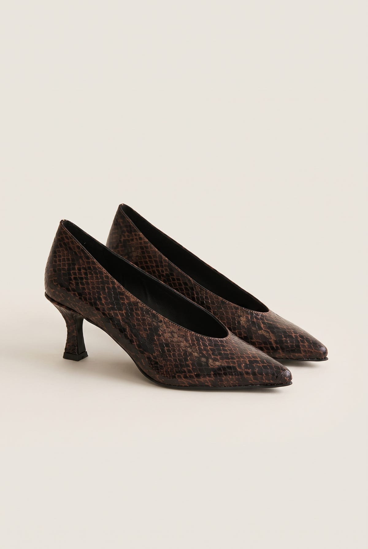 Pair of brown snake-print pointed-toe kitten heel pumps placed side by side with toes pointing right
