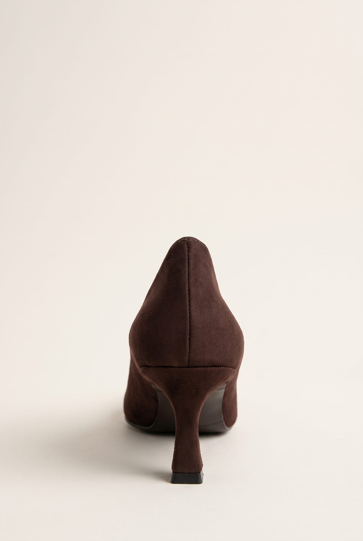 Back view of brown suede pump with a smooth heel counter, slim kitten heel and clean rounded sole edge