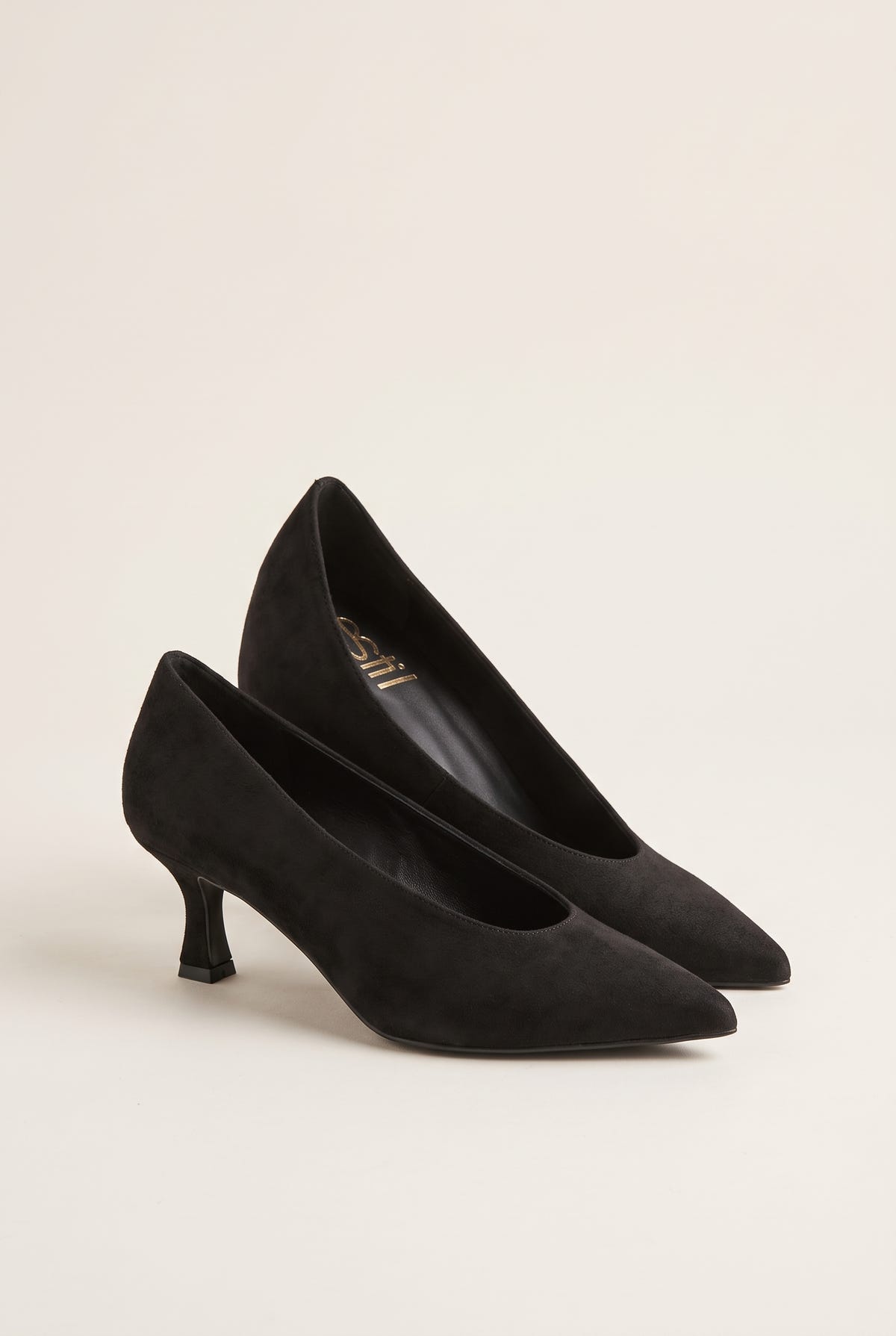 Pair of black suede pointed-toe kitten heel pumps placed side by side with toes pointing to the left