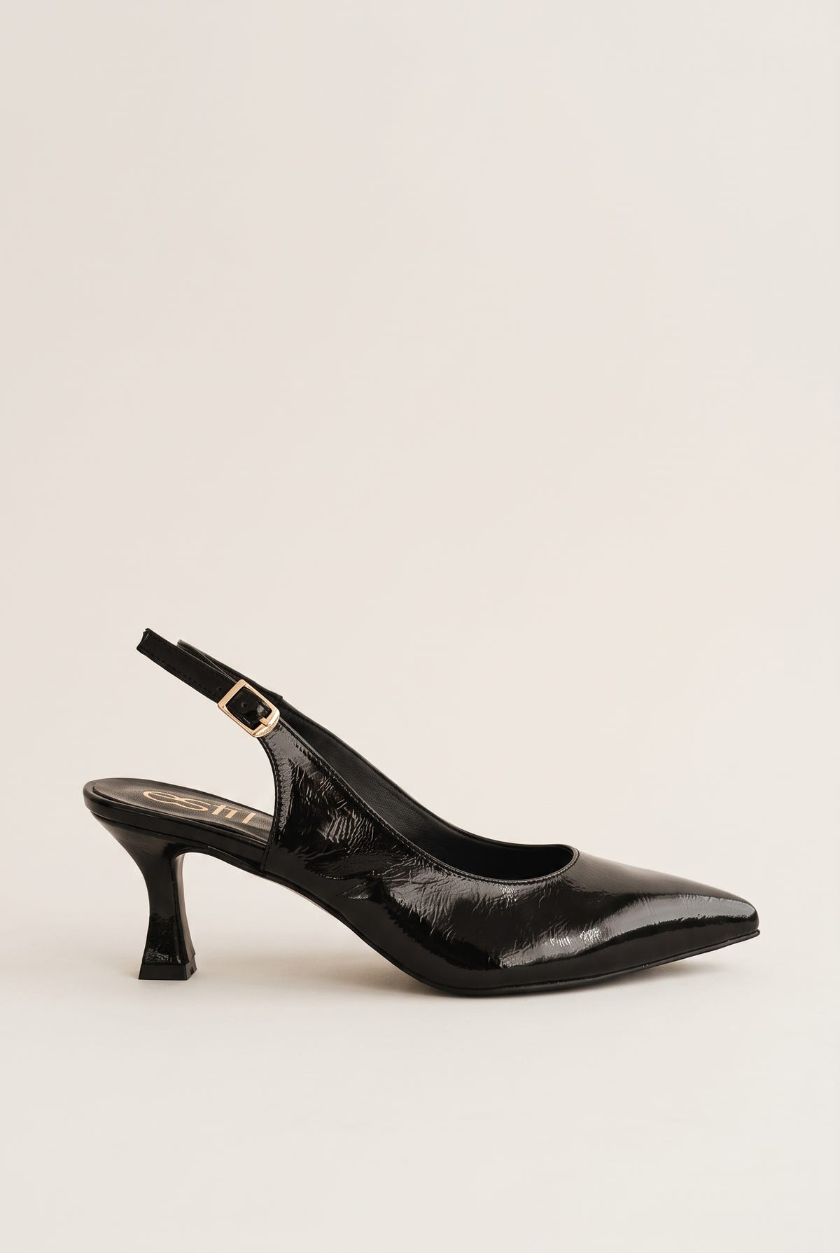 Side view of black patent slingback with pointed toe, gold-tone buckle strap and slim kitten heel