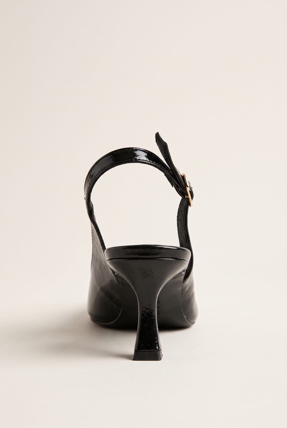 Back view of black patent slingback showing the strap across the heel and slim kitten heel