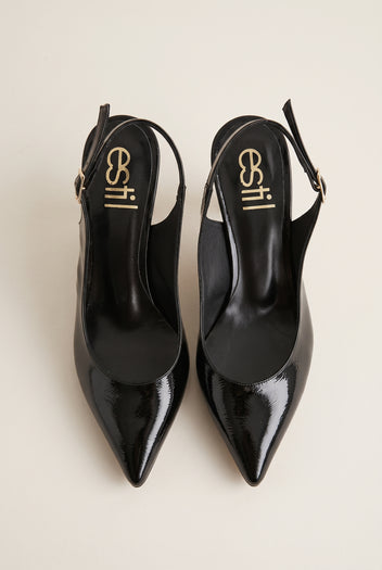 Top view of black patent slingback pumps with glossy buckled straps, pointed toes and black leather insoles