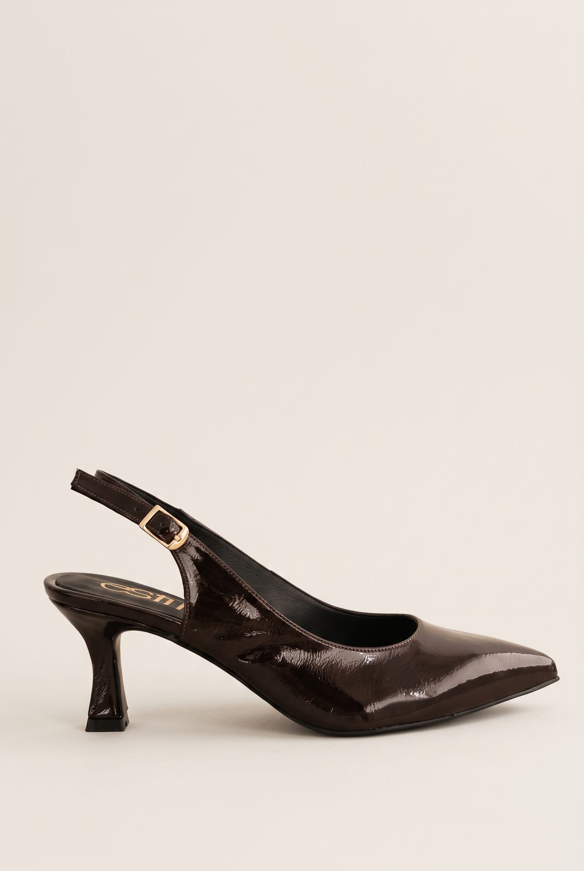 Side view of brown patent slingback with pointed toe, gold-tone buckle strap and slim kitten heel