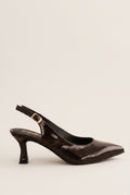Side view of brown patent slingback with pointed toe, gold-tone buckle strap and slim kitten heel