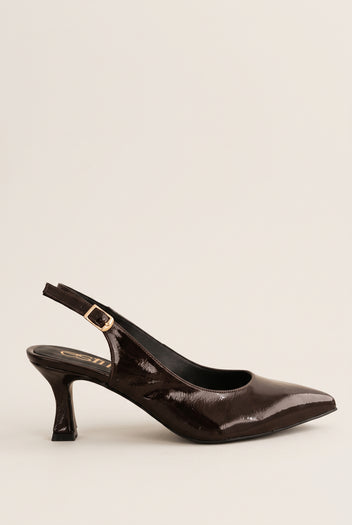 Side view of brown patent slingback with pointed toe, gold-tone buckle strap and slim kitten heel
