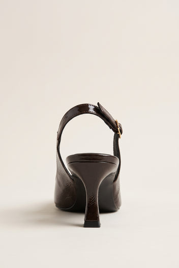 Back view of brown patent slingback showing the buckled strap and narrow kitten heel
