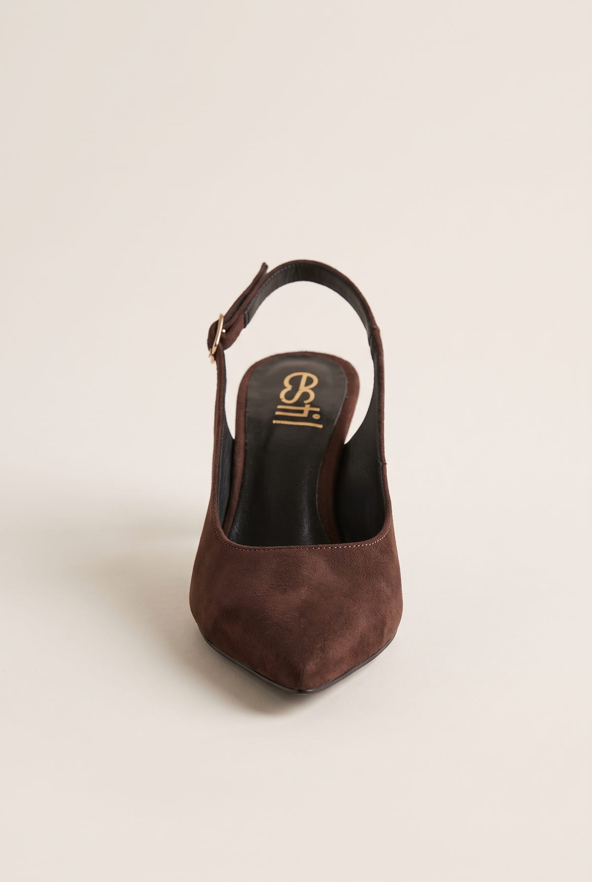 Front view of brown suede slingback pump showing the pointed toe and strap behind the heel