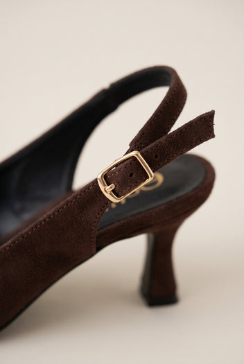 Close-up of brown suede slingback showing the gold-tone buckle on the strap and slim kitten heel