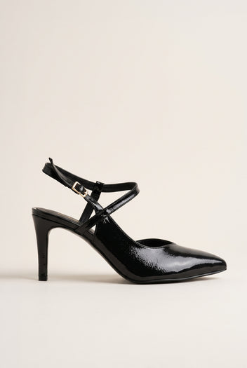 Side view of a black patent pointed toe slingback pump with a crossed ankle strap and slim high heel