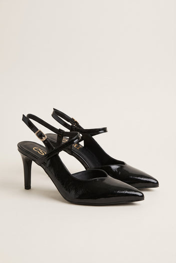 Pair of black patent slingback pumps placed together in side view with crossed ankle straps