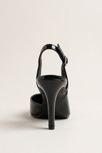 Back view of a black patent slingback pump showing the open heel, ankle strap and slim heel