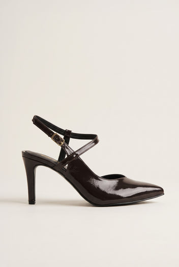 Side view of a single brown patent slingback pump with crossed ankle straps and slim high heel