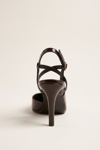 Back view of a brown patent slingback pump with crossed ankle straps and a slim stiletto heel