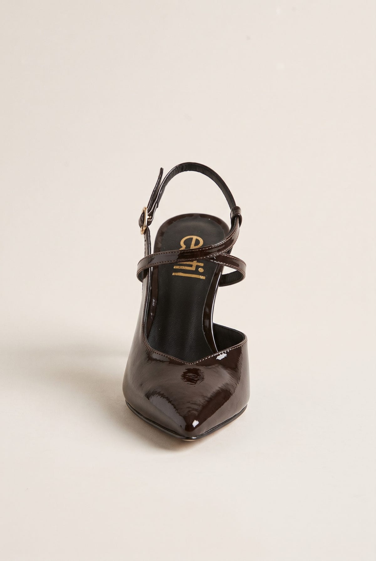 Front view of a brown patent slingback pointed pump with a thin ankle strap and open back