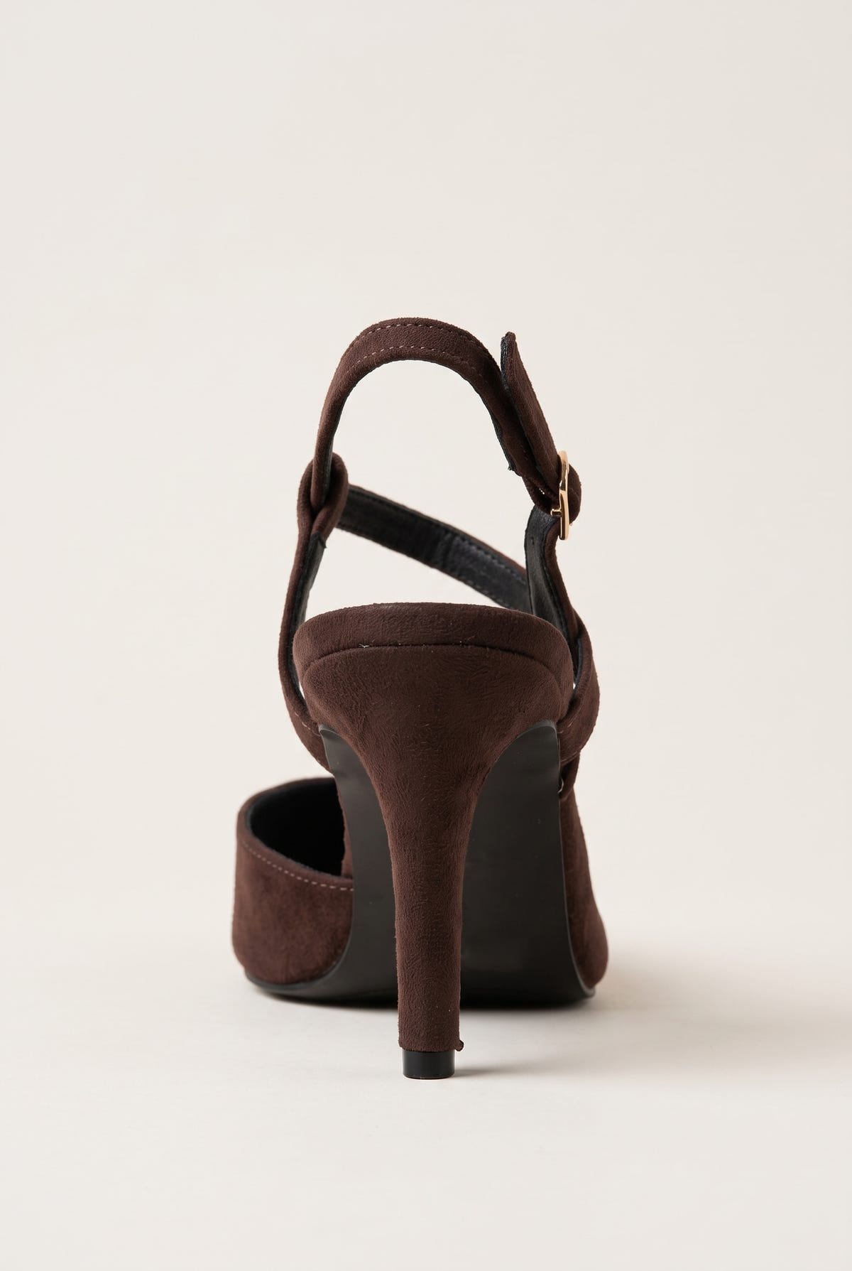 Rear side view of brown suede slingback pump showing open heel counter and slender stiletto heel
