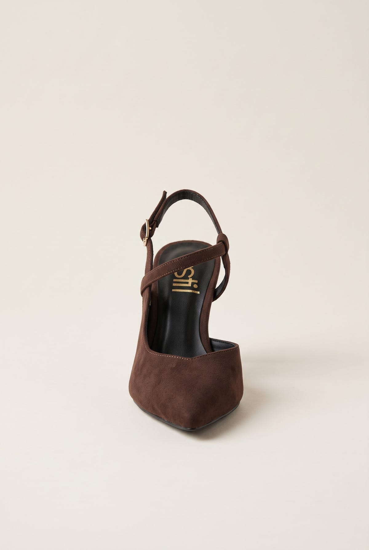 Rear angle of brown suede slingback pump with narrow ankle strap buckled over the open heel