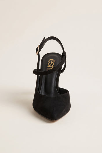 Rear three-quarter view of black suede slingback pump with ankle strap buckle and open heel