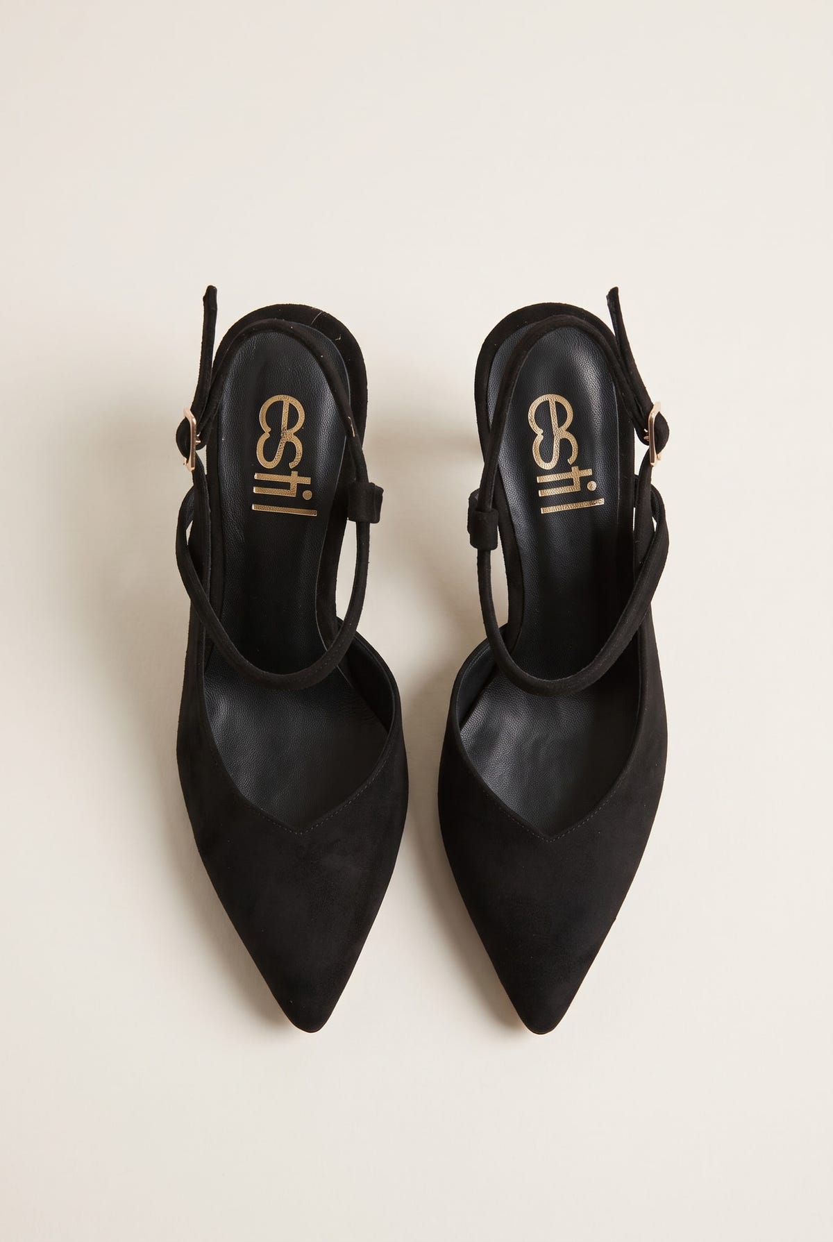 Top view of black suede pointed slingback pumps with narrow heel straps and buckled ankle details