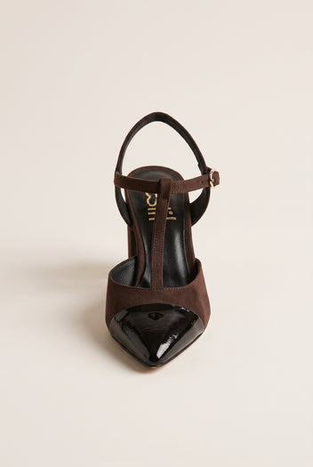 Front view of chocolate suede T-strap pump with black patent pointed toe cap and narrow ankle strap