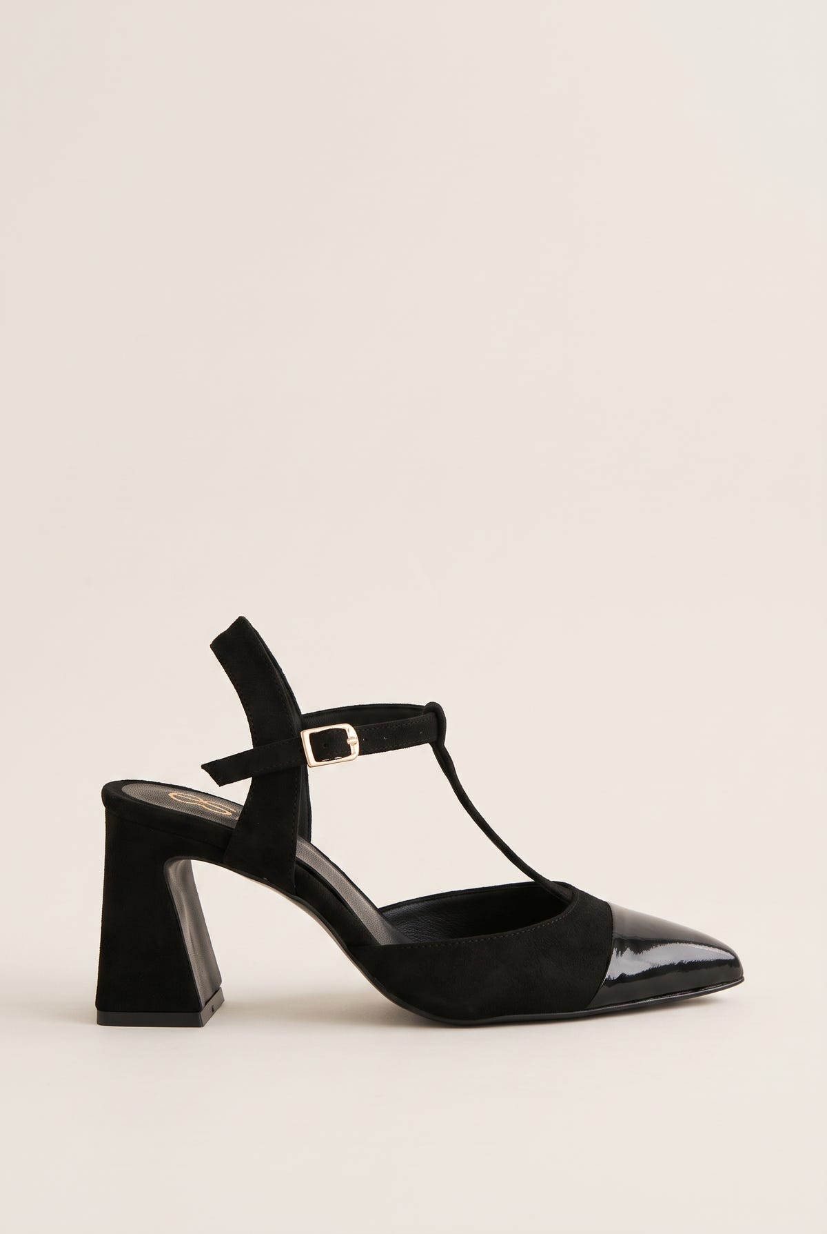 Black suede and patent T-strap pump with patent toe cap and buckle ankle strap in side view